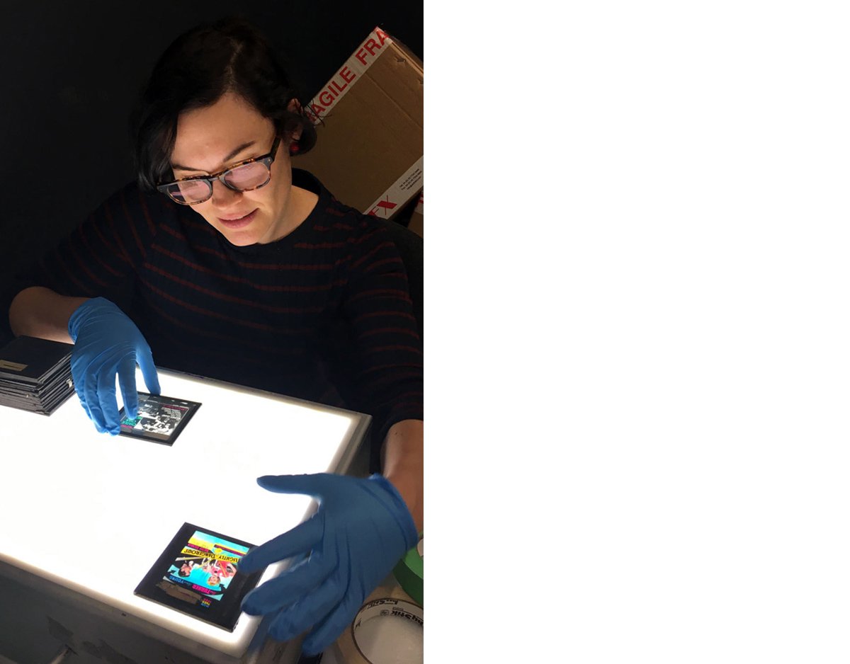 Assistant Curator Chelsey O’Brien examines some of the magic lantern slides from EAFA