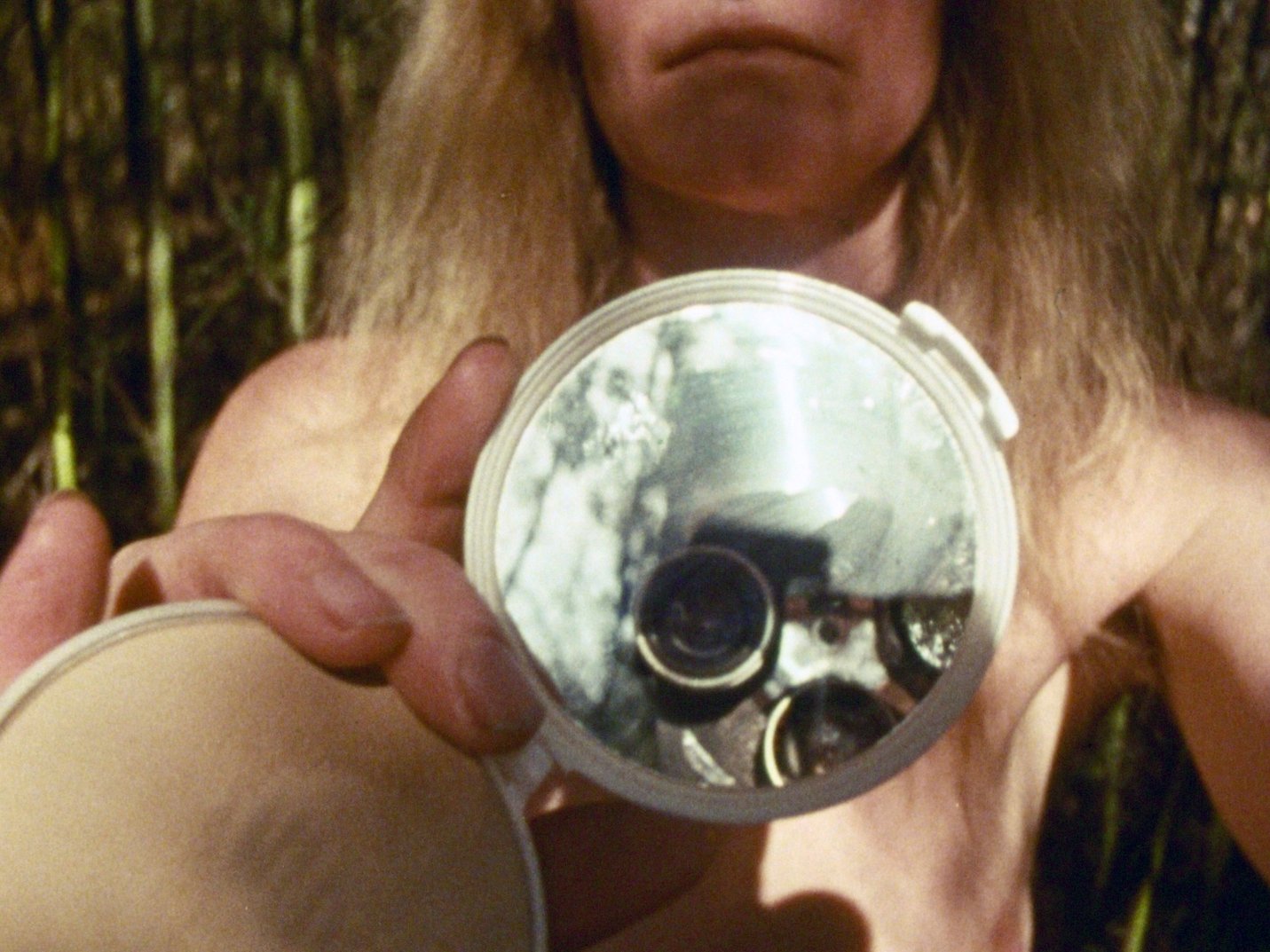 Closeup of clamshell mirror - still from Time changes, 1978