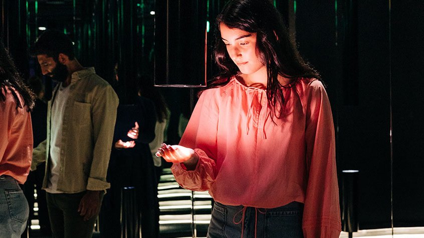 A young woman interacting with Memory Garden in ACMI's Story of the Moving Image exhibition (Adam Gibson)