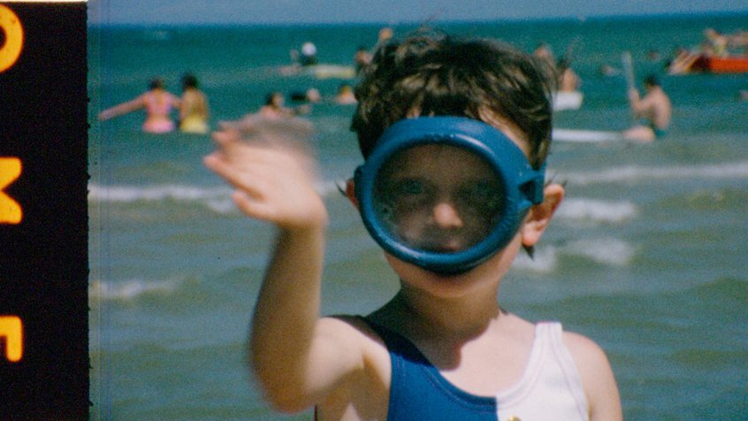 Film reel from the ACMI Collection - A kid wearing a snorkel and waving.jpg