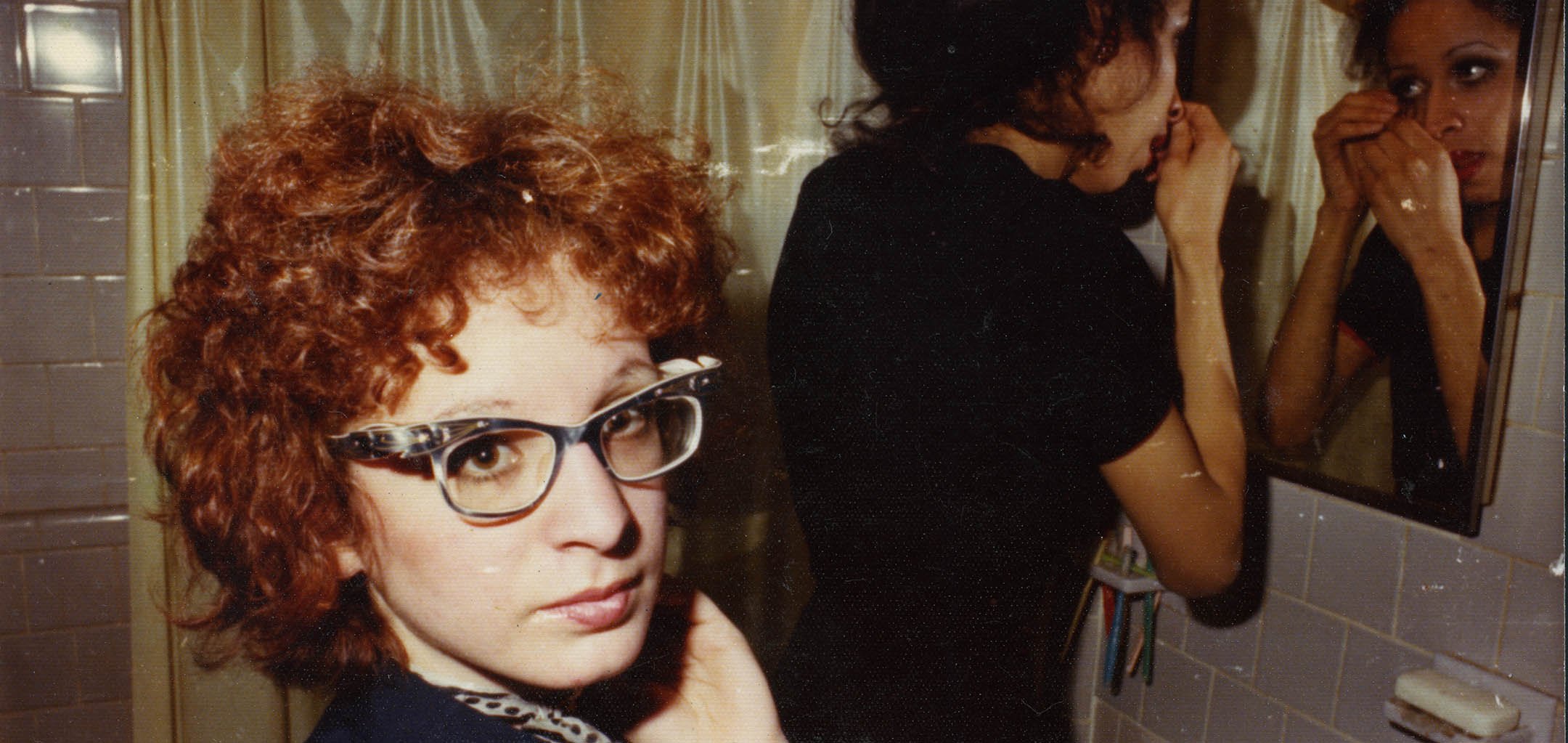 Nan in the bathroom with roommate Boston (Photo courtesy of Nan Goldin)