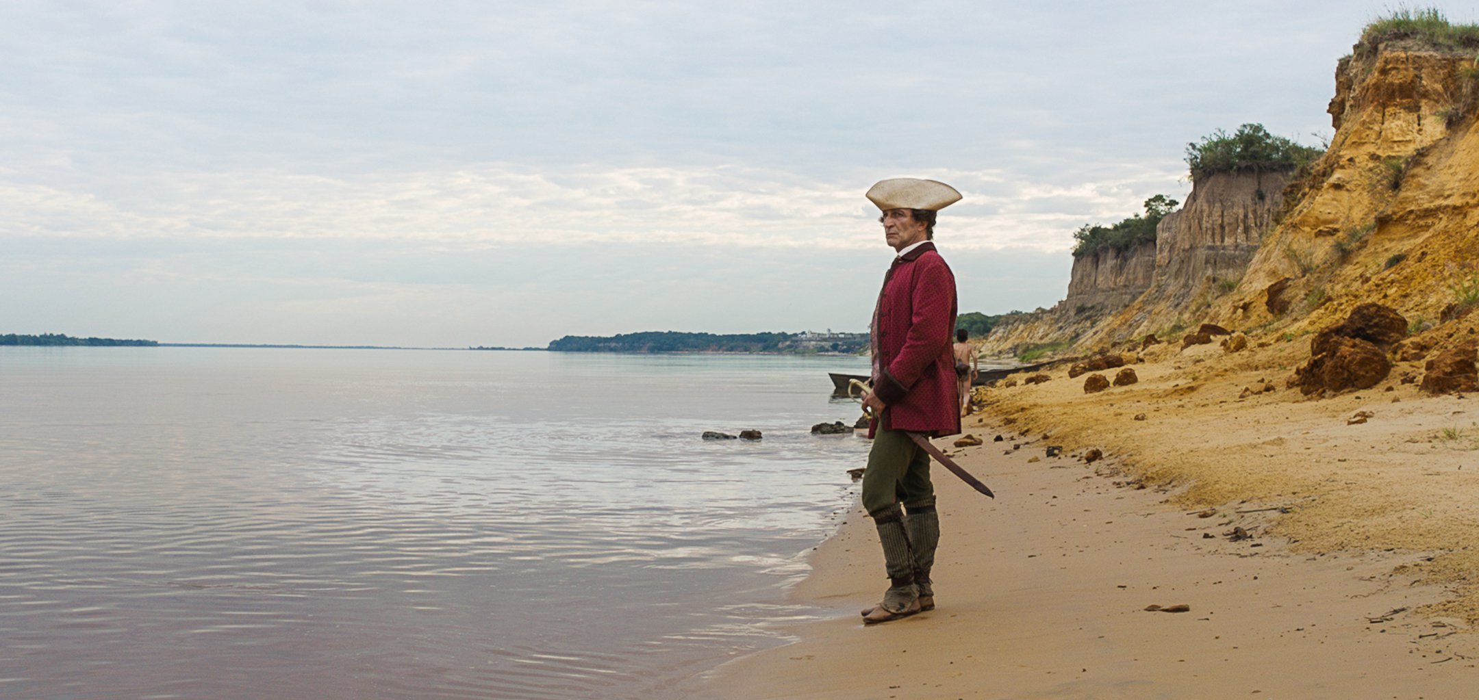 Daniel Giménez Cacho standing on a beach in a still from 'Zama' (2017)