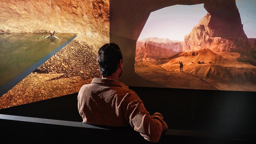 A man seated and experiencing the Out of Bounds exhibition at ACMI - image credit Phoebe Powell
